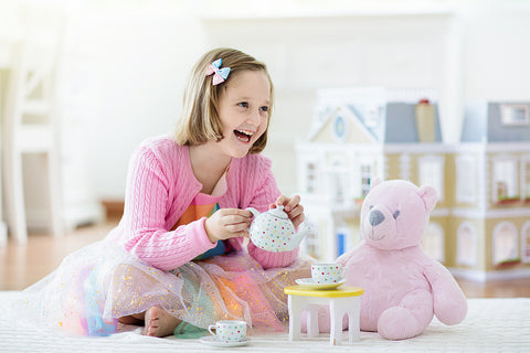 little girl playing with stuffed animal