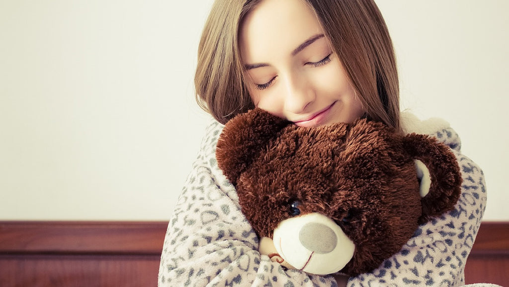 woman hugging stuffed animal